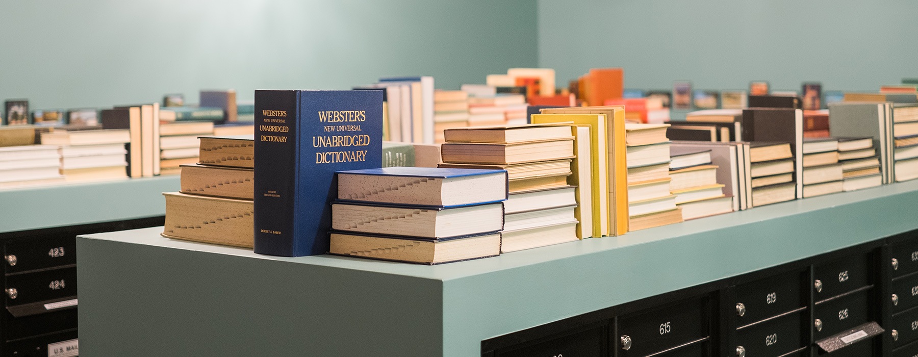 image of books on top of large mail room storage areas