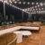 outside rooftop lounge with string lights and seating